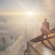 Agent 47 stands on top of a tower in Dubai and looks at a cloudy landscape in Hitman 3.